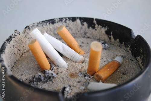 Assorted cigarette butts in an ashtray