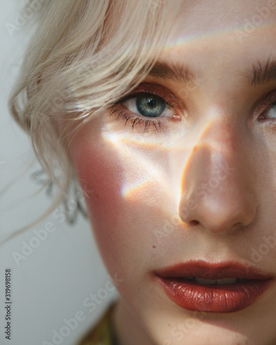 Fashion beauty portrait of young beautiful woman with sunny bunny on her face