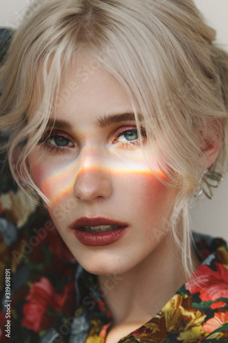 Fashion beauty portrait of young beautiful woman with sunny bunny on her face