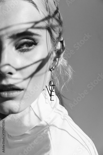 Fashion beauty portrait of young beautiful woman with shadows. Black and white