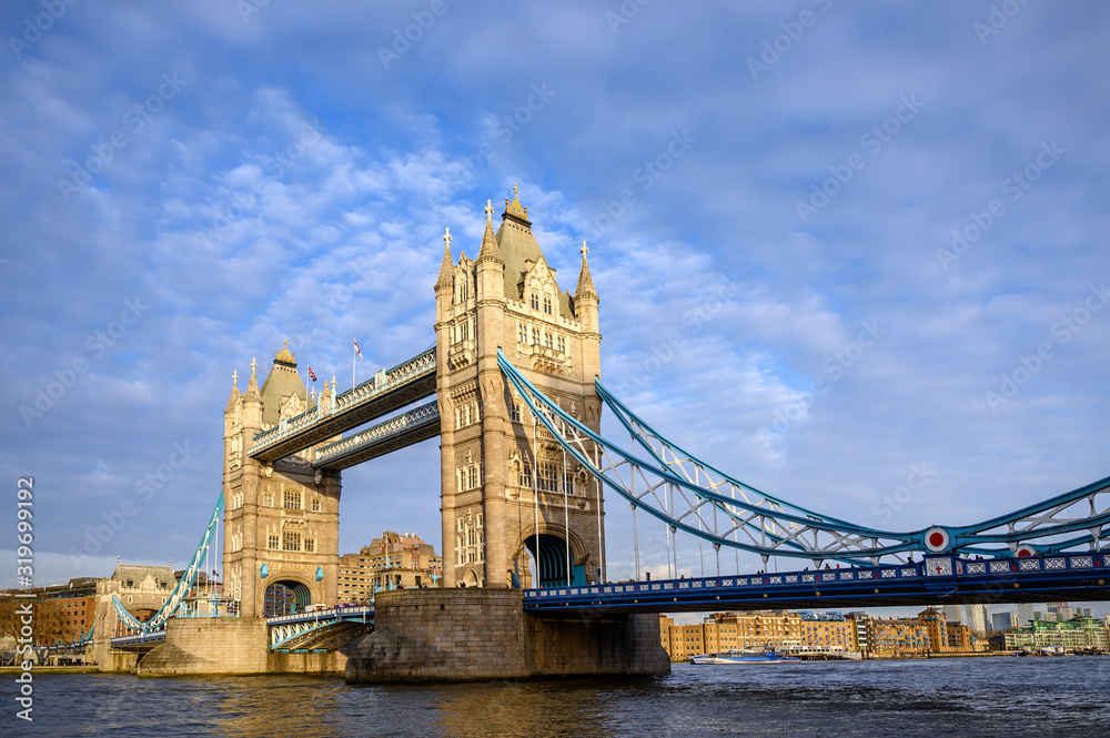Tower Bridge in the City of London, UK. Tower Bridge crosses the River Thames and is one of the most famous tourist sights in London. Wide angle view of Tower Bridge in late afternoon light.