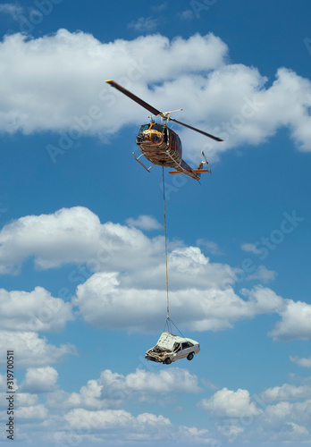 Helicopter lifting a car