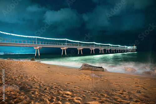 Pont del petroli puente en el mar en la playa de badalona barcelona photo