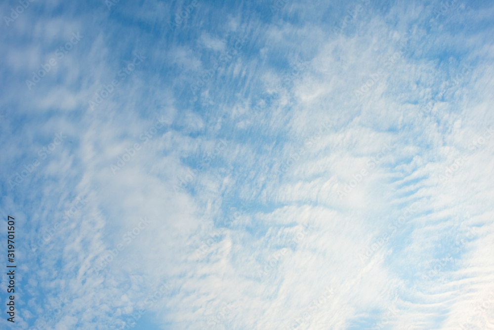Blue sky with white clouds, (Cirrocumulus clouds)  in blue sky on sunny peaceful day.
