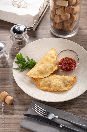 Uzbek eastern Tatar cuisine, cheburek with meat and suluguni cheese. Cheburek fried pie with meat and onions. Traditional dish of Turkish and mongolian. national dish of the Crimean Tatars. Homemade F photo