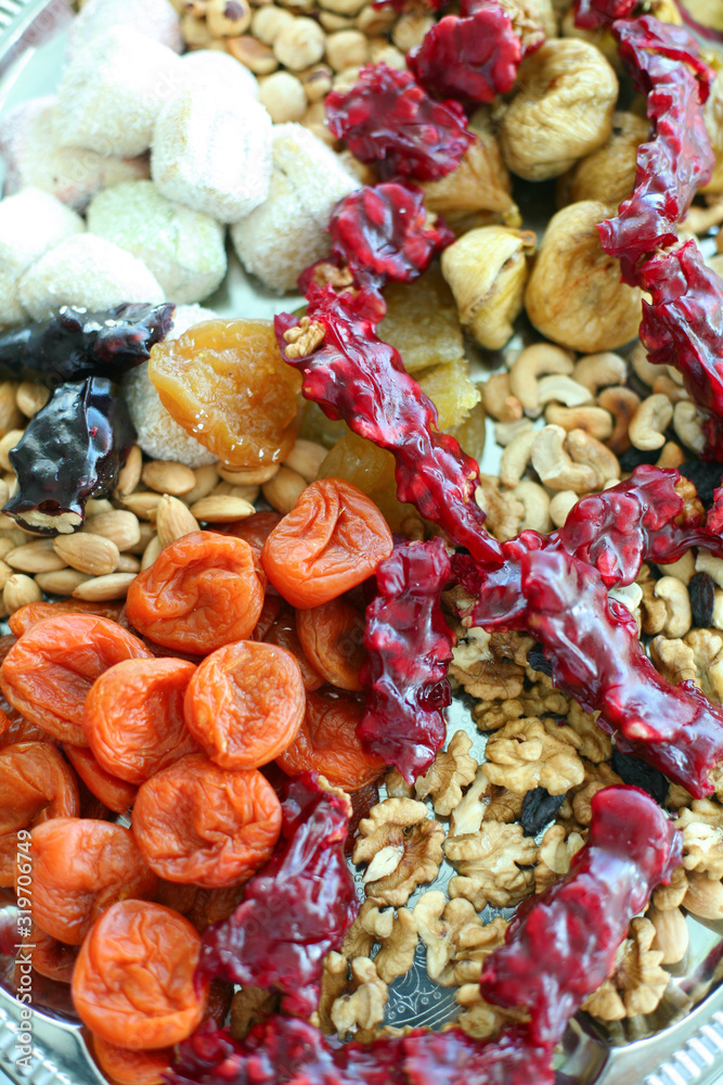 Different colorful dried fruit and nuts close-up. Food background.