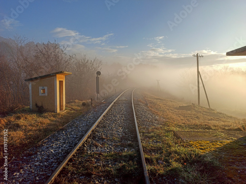 Train rail cross in a foggy winter morning