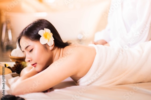 Asian Beautiful  young and healthy woman in spa salon. Massage treatment spa room  . Traditional medicine and healing concept.