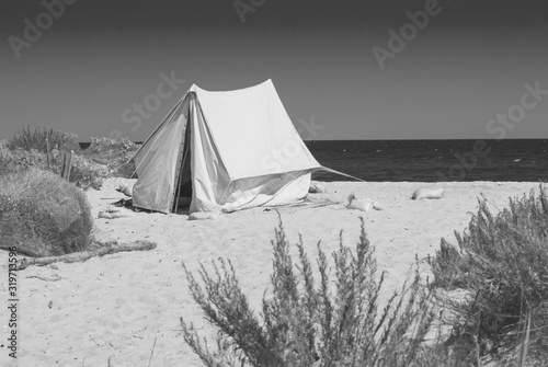 Tent on a beach. Monochrome