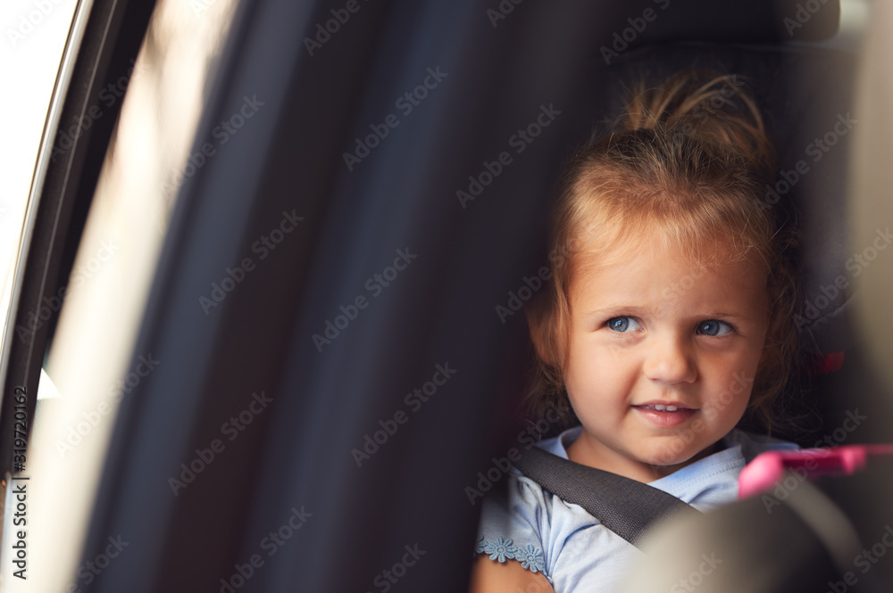 Young Girl Watching Digital Tablet In Back Seat On Car Journey Young Girl Watching Digital Tablet In Back Seat On Car Journey