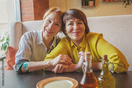 Two happy mature women in restaurant photo