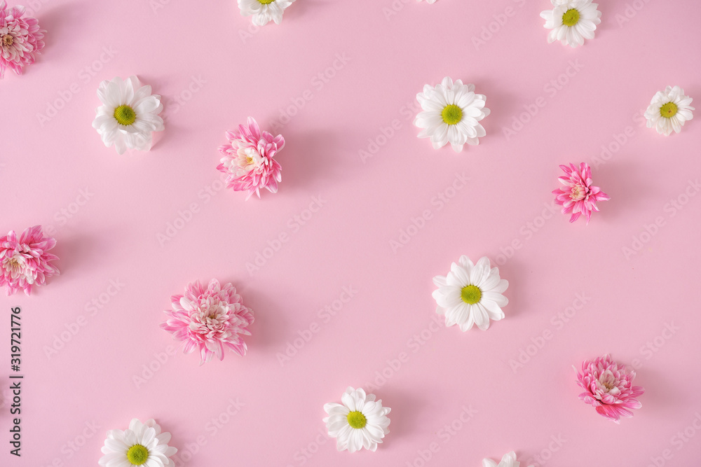 Fototapeta premium Creative pattern made with pink and white flowers on pastel pink background. Flat lay. Spring minimal concept.