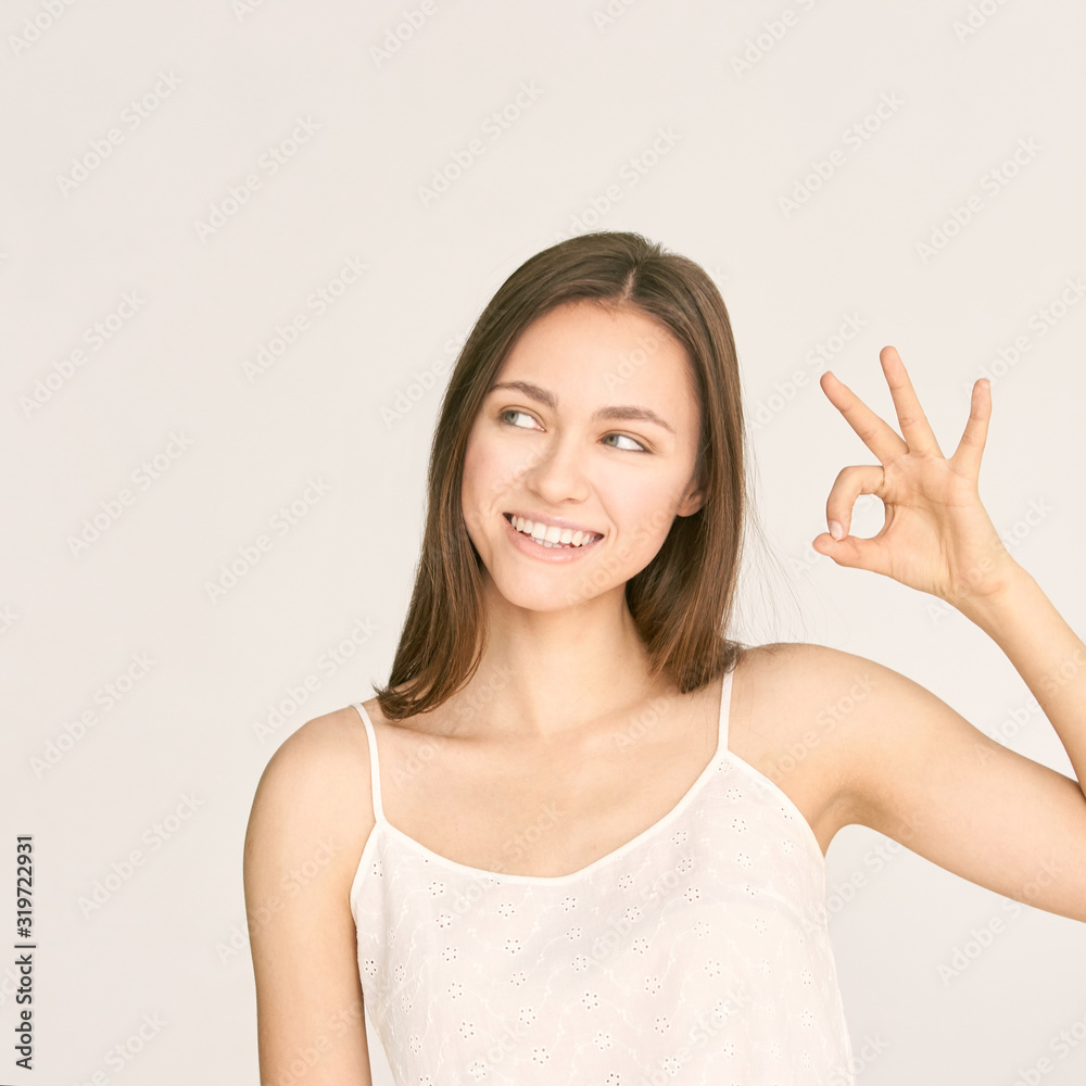 Young beauty girl sign ok. Zero gesture woman smile portrait. Female people hand show approve symbol. Copyspace Young beauty girl sign ok. Zero gesture woman smile portrait. Female people hand show approve symbol. Copyspace