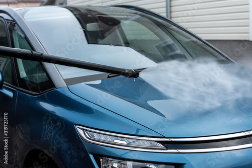 Process of car washing using high pressure water.