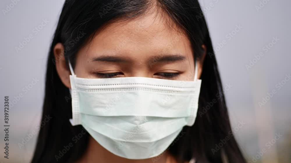Asian women wearing dust mask and headache protect from wuhan coronavirus china health emergency. Asian women wearing dust mask and headache protect from wuhan coronavirus china health emergency.
