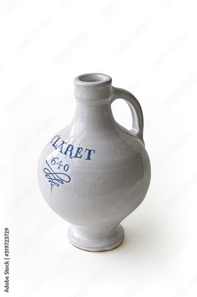 A 17th Century white glazed stoneware bottle with the word Claret and the date painted onto it.