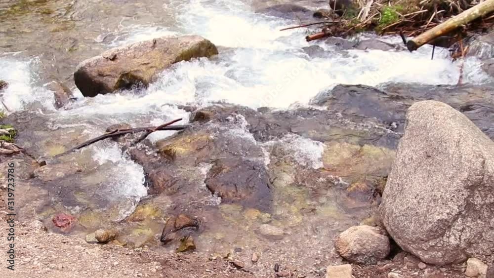 A large amount of water flows down from sharp gray stones. Waterfall A large amount of water flows down from sharp gray stones. Waterfall