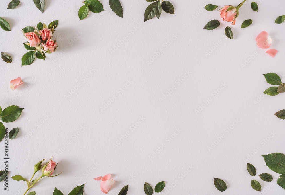 Fototapeta premium Rose pastel pink flowers and leaves. Spring or summer frame background. Flat lay social mockup with copy space.