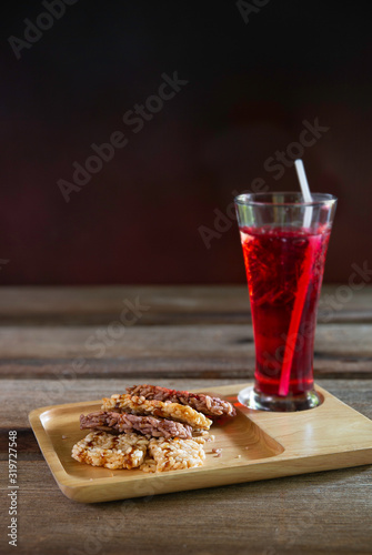 Thai Sweet crispy rice dessert and sprinkle with cane sugar, thai dessert thai name *Khao tan* photo