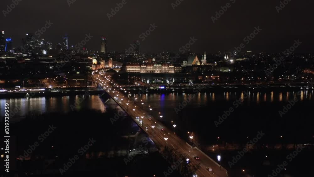 Aerial view of the historic center of the old city in Warsaw, view of the river hung and the bridge at night. Poland.