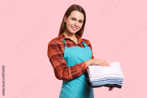Young housewife with laundr...