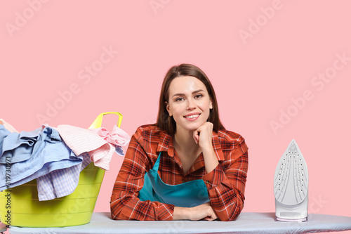 Young housewife with laundr...