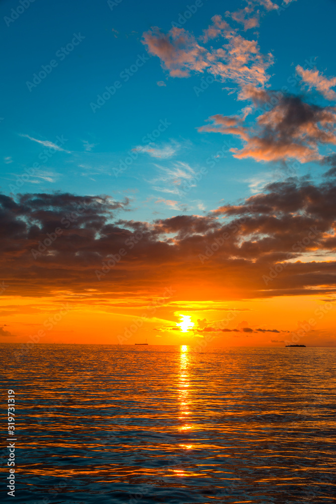 Amazing Sunset view at Indian ocean  Colorful nature scenery orange and blue shade cloudy sky, Vertical sea sunset background image