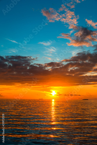 Amazing Sunset view at Indian ocean Colorful nature scenery orange and blue shade cloudy sky, Vertical sea sunset background image