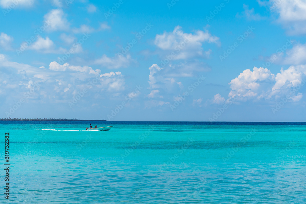 Beautiful Beach Nature Scenery of Maldive Funadhoo Island colorful sea and blue cloudy sky with alone boat Luxury travel summer holiday background concept