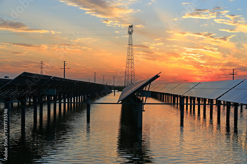 Solar photovoltaic panels in the water  in the sunset sky background