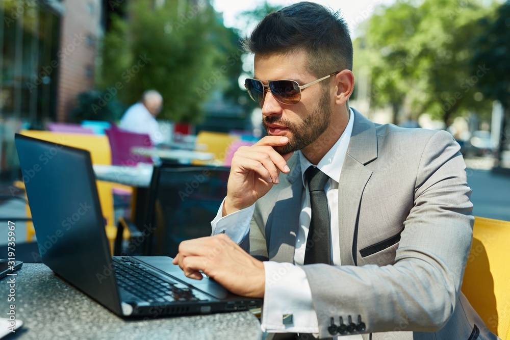 Portrait of businessman with laptop at cafe Portrait of businessman with laptop at cafe