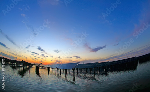 Solar photovoltaic panels in the water  in the sunset sky background