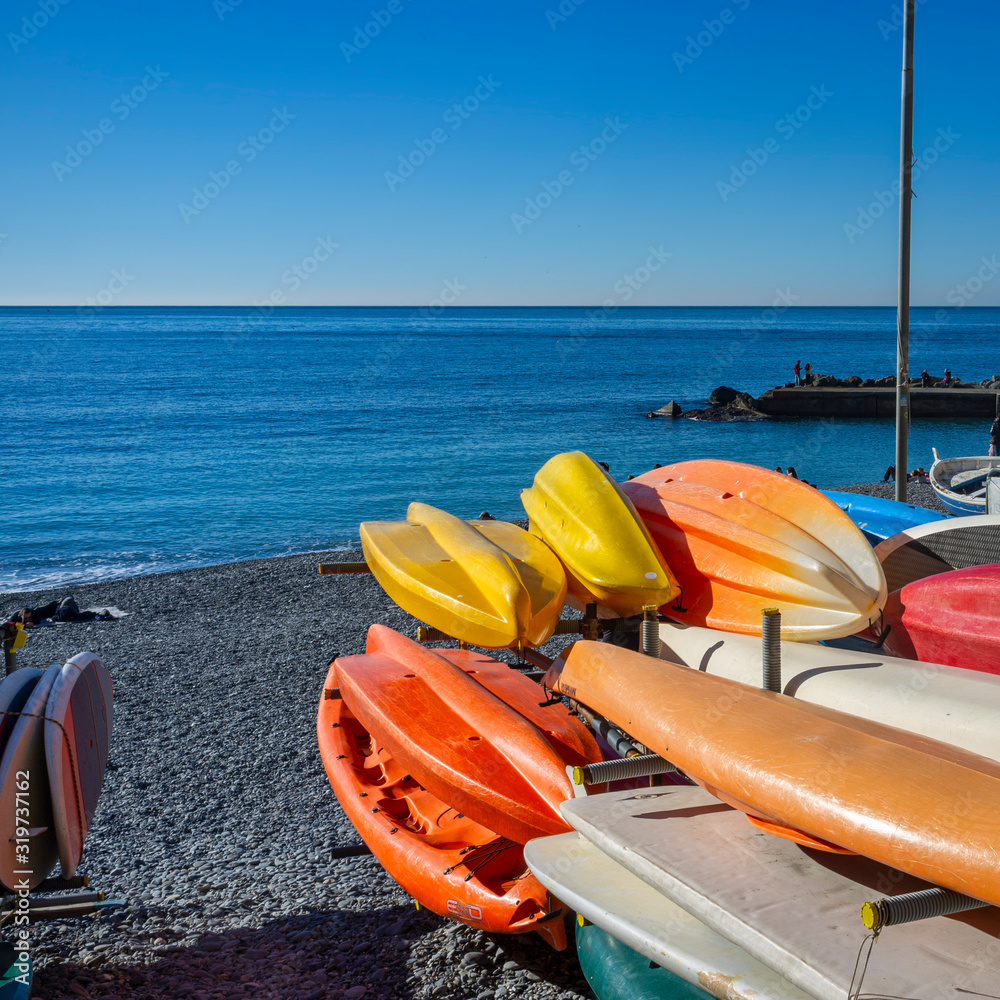Canoes stored on the beach of Zoagli, along the shores of the Ligurian Sea (Genoa Province Italy) during winter season. Canoes stored on the beach of Zoagli, along the shores of the Ligurian Sea (Genoa Province Italy) during winter season.