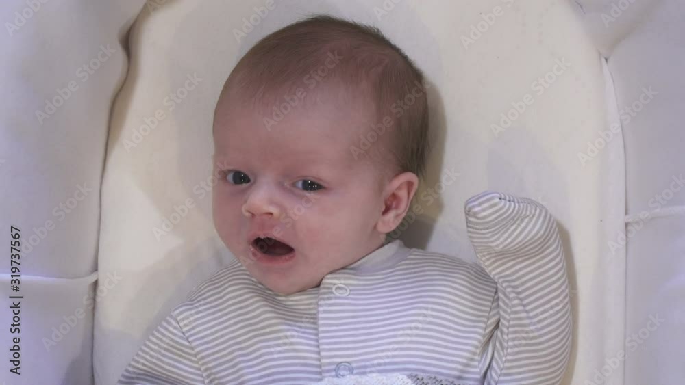 4K: Tired baby yawning in Moses Basket with a blanket on. Aerial view - Looking down 4K: Tired baby yawning in Moses Basket with a blanket on. Aerial view - Looking down
