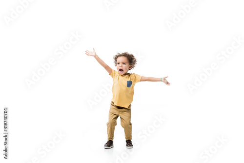 excited little african american boy gesturing isolated on white