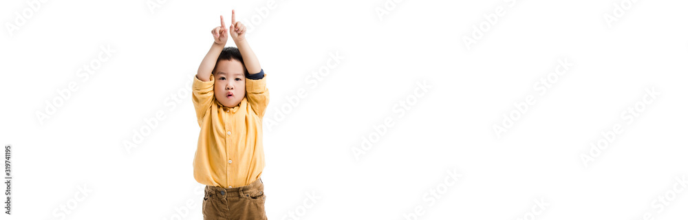 panoramic shot of surprised asian boy pointing up isolated on white panoramic shot of surprised asian boy pointing up isolated on white