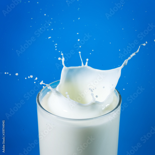 pouring milk in a glass isolated photo