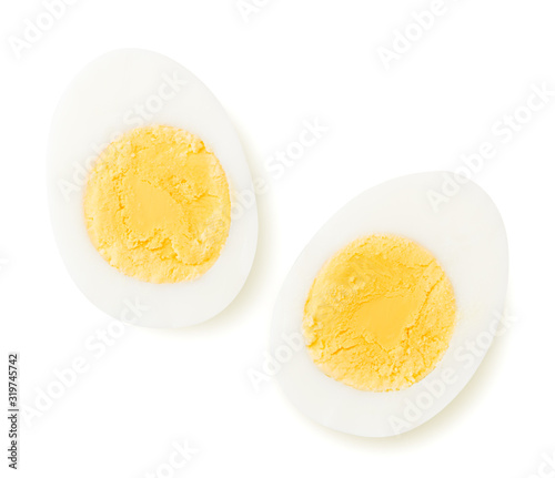 Fotografia Two halves of a boiled egg on a white. The view from the top