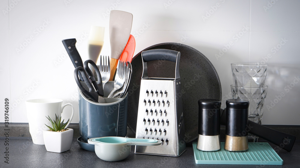 Kitchen utensils on the background of the kitchen. Close-up. .Set of dishes and kitchen utensils on a background. Kitchen utensils on the background of the kitchen. Close-up. .Set of dishes and kitchen utensils on a background.