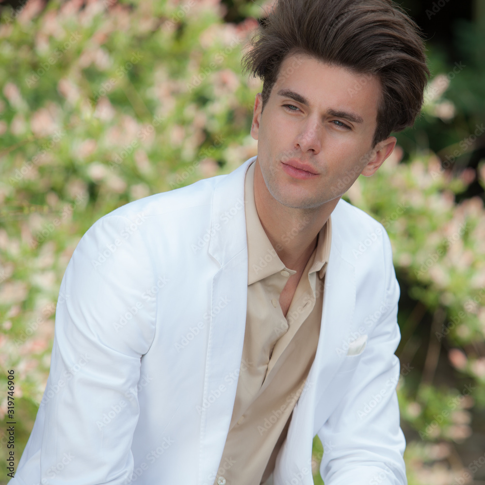 Young elegant handsome man posing outside. Young elegant handsome man posing outside.