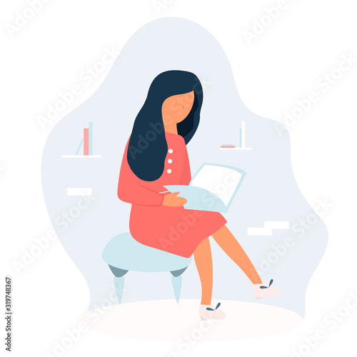 Girl sitting and reading a book in a room.