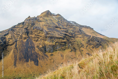 Huge mountain near a field of grass