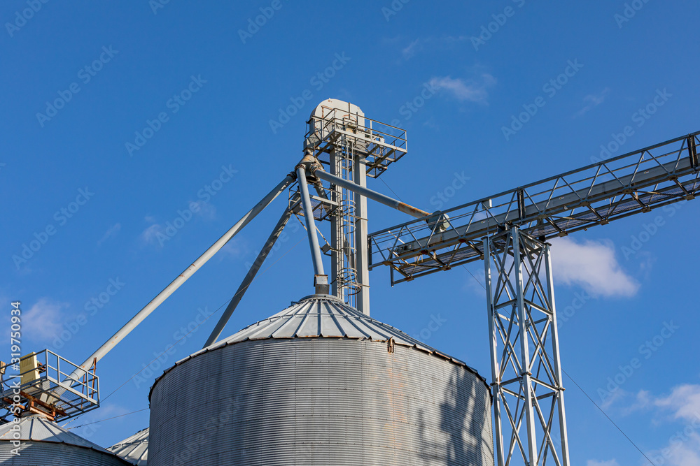Looking up at grain elevator storage bin and elevator leg conveyor system Looking up at grain elevator storage bin and elevator leg conveyor system