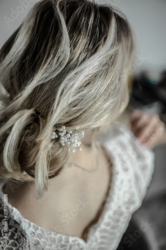 Fashion wedding hairstyle. Hair do with an elegant hair accessorie. Black and white photo