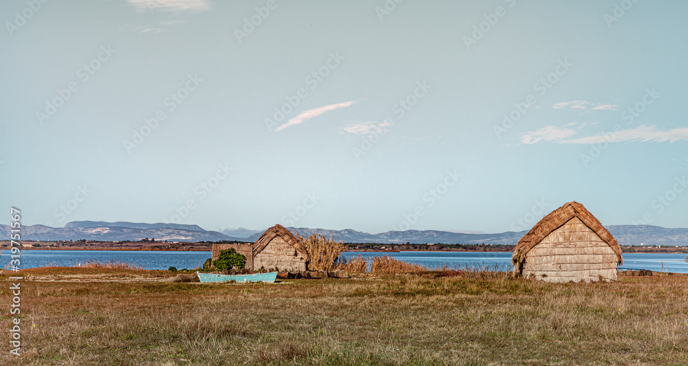 Historic fishing village and the Etang de Canet lagoon and Canigou in the background Historic fishing village and the Etang de Canet lagoon and Canigou in the background