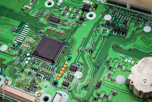 Green system board with microchips and transistors.