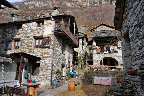 Fondo, Piedmont, Italy - January 20, 2020: old abandoned rustic mountain houses made of local stone in the ancient village of Fondo, in a winter morning © Marco