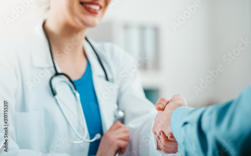 фотографія Detail of Doctor and Patient Handshake