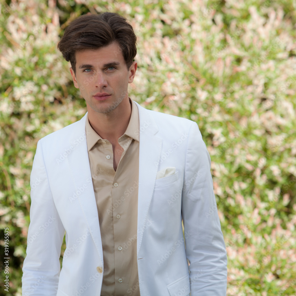 Young elegant handsome man posing outside.