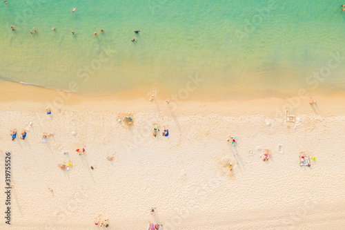 Aerial panorama of tropical resort territory and beach, beautiful Andaman sea at west coast of Phuket Island. Kata Noi beach from above, some buildings and green hills, calm sea surface to horizon